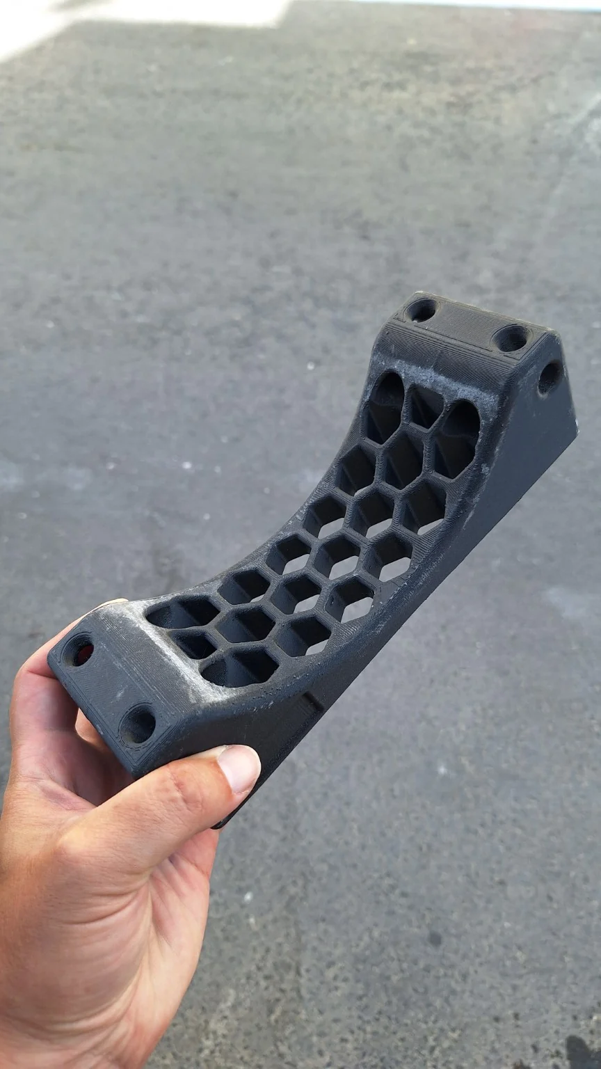 The single 3D-printed cradle I use under each scuba cylinder to prevent it rolling in the car